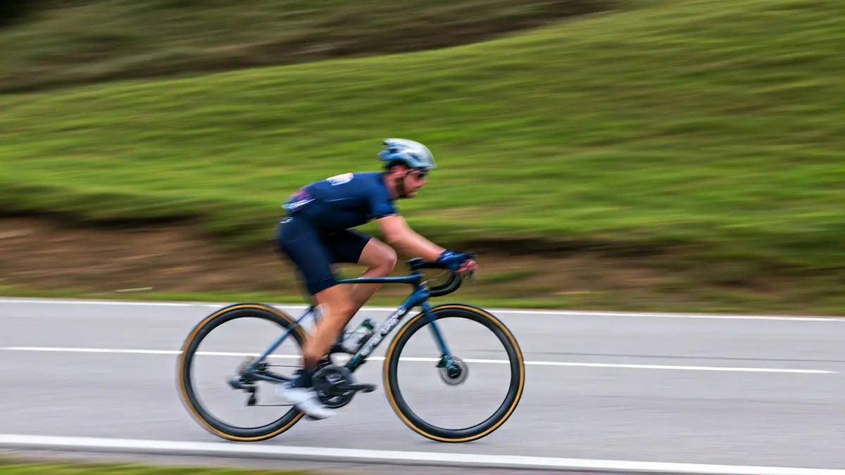 Generic image of a bicycle wheel with a blurred road in the background.