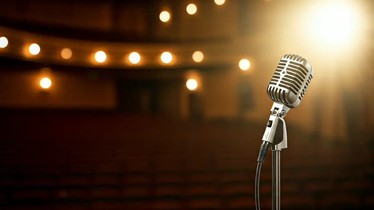 Generic image of a microphone on a theater stage.