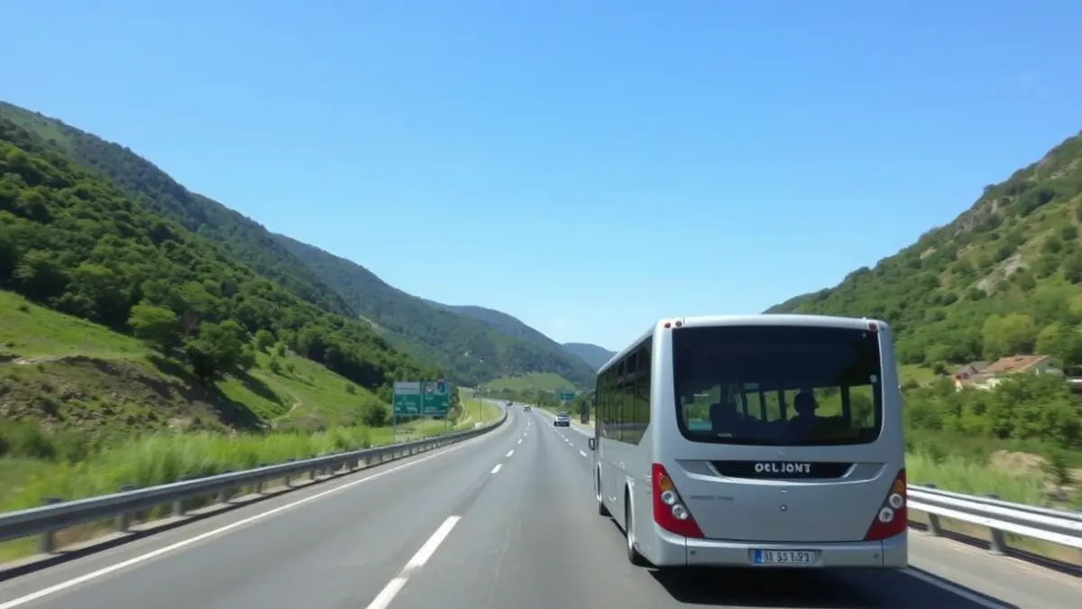 Generic image of a bus on a road, amidst green mountains.