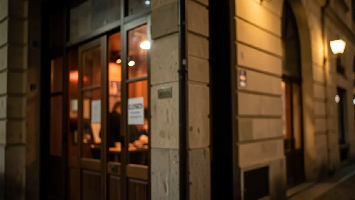 A blurred image of a closed concert venue at night, with warm lights and a 'Closed' sign.