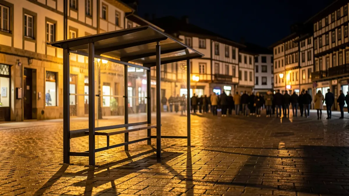 Generic image: Night, an empty bus stop in a Basque town, warm lights.